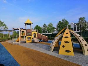 a playground with several slides and a play structure at Homestay Greenway in Pasir Gudang