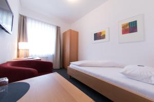 Un pat sau paturi într-o cameră la Energiehotel Kultiviert