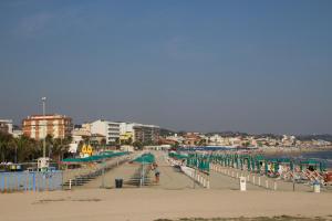 a beach with chairs and umbrellas and the ocean at B&b Sogni d'oro Milena in Civitanova Marche