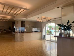 a lobby of a store with a lobbyasteryasteryasteryasteryasteryasteryasteryastery at Hotel Roca Bella in Es Pujols