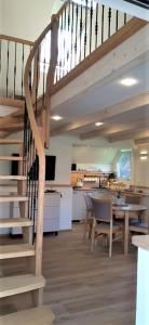 a room with a staircase and a table and a kitchen at "Pamario Namelis" - Preiloje in Neringa