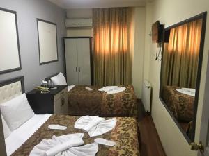 Postel nebo postele na pokoji v ubytování Meddusa Hotel