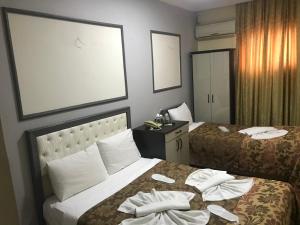 Postel nebo postele na pokoji v ubytování Meddusa Hotel