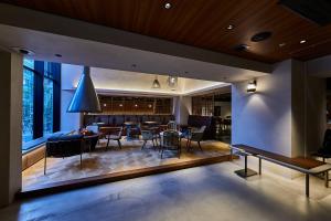 a dining room with a bar with chairs and a table at THE TOURIST HOTEL & Cafe AKIHABARA in Tokyo