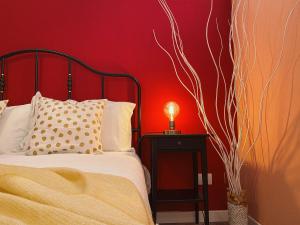 a bedroom with a bed and a red wall at WellHome Asti Premium Apartments with Private Terrace & Garden in Asti