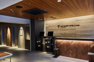 an office with a reception desk with a sign on the wall at THE TOURIST HOTEL & Cafe AKIHABARA in Tokyo