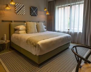 
a bedroom with a large bed and a large window at Agata Hotel Boutique & Spa in Mexico City

