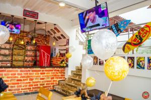 a room with balloons and a staircase in a store at Hostal Casa Roma in Taganga +40 photos
