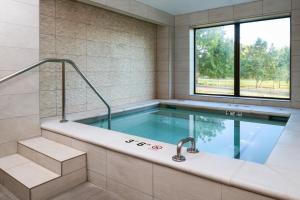 a swimming pool in a building with a window at The Independence Hotel in Independence