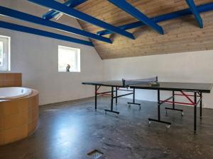 uma mesa de pingue-pongue num quarto com uma banheira em 16 person holiday home in Ulfborg em Ulfborg