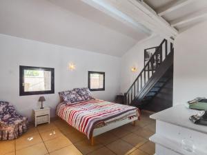 a bedroom with a bed and a stair case at Countryside holiday home with pool in Renaison