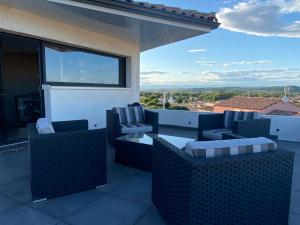 a patio with chairs and a table on a balcony at Fun and sun room in Salles-d'Aude