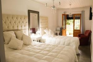מיטה או מיטות בחדר ב-Campos do Jordão Suites