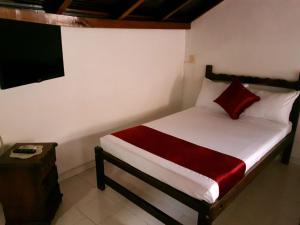 Letto o letti in una camera di Hotel Don Juan Colonial
