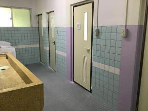 a bathroom with purple and white tiled walls at Shimaotoya in Iriomote +30 photos