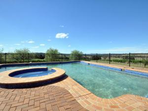 a swimming pool with a brick patio and anergynergynergynergyploadploadpload at Beggars Bridge Vineyard Homestead with pool and tennis in Rothbury