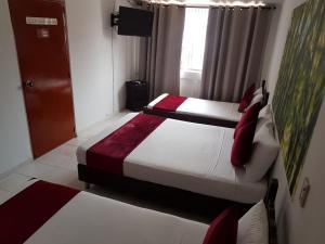 Letto o letti in una camera di Hotel Don Juan Colonial