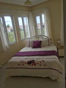a bedroom with a large bed with flowers on it at Cosy Villa With Communal Pool, Rooftop Suntrap Area in Ilıcaköy