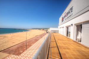 a view of the beach from the balcony of a building at Apartamentos Playa Barbate in Barbate