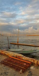 two boats sitting on the shore of a body of water at Buorana in Chon Buri