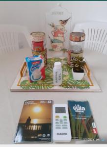 a table with a tray with food and a remote control at jazmin1 in Colonia del Sacramento