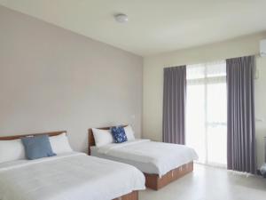 Giường trong phòng chung tại 響樂池上電梯民宿1663 Chishang Music Guesthouse
