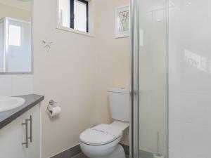 a bathroom with a toilet and a glass shower at Island Sands in Cowes +11 photos