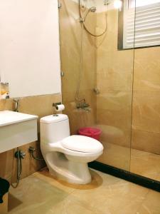 a bathroom with a toilet and a shower at Dew Drops Boutique Retreat in Igatpuri