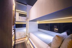 a small room with two bunk beds in it at CUBE Family Boutique Capsule Hotel at Chinatown in Singapore