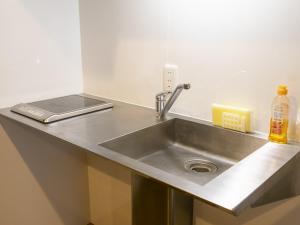 a kitchen counter with a sink in a kitchen at Hotel Pescatore Okinawa in Naha