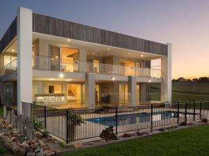a large house with a pool in front of it at Ocean Breeze in San Remo