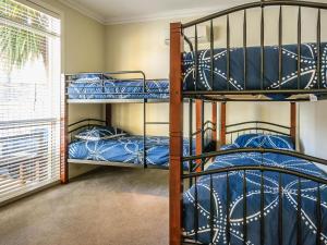 two bunk beds in a room with a window at On Chapel in Cowes