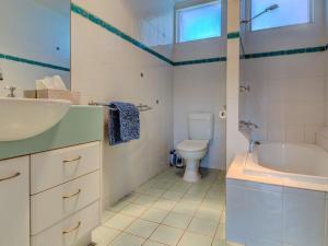 a bathroom with a sink and a toilet and a tub at Raywood in Cowes +17 photos