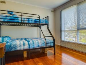 a bunk bed in a room with a window at Raywood in Cowes