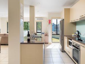 a kitchen and living room with a couch at Penguins by the Beach in Cowes