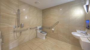 a bathroom with a shower and a toilet and a sink at Atherton Apartments in Atherton +21 photos