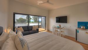 a bedroom with a large bed and a living room at Atherton Apartments in Atherton