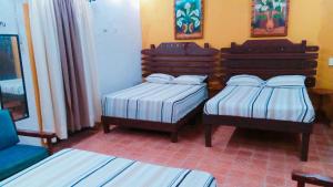 Un pat sau paturi într-o cameră la Hostal Villa Mercedes