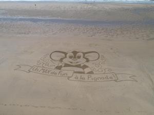a drawing of a monkey in the sand on a beach at Camping Officiel Siblu La Pignade in Ronce-les-Bains