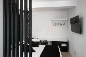 a bedroom with a bed and a chair in a room at Hotel La Compagnia Del Viaggiatore in LʼAquila
