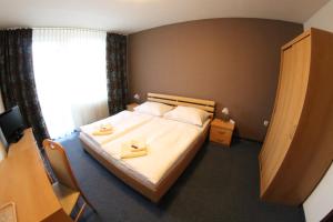 Ein Bett oder Betten in einem Zimmer der Unterkunft Hotel SPECTRUM