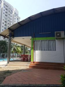 a gas station with a blue and green building at Marina Apartment 3R2B in Kampong Baharu