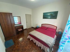 a bedroom with a bed with a red bedspread at Marina Apartment 3R2B in Kampong Baharu +10 photos