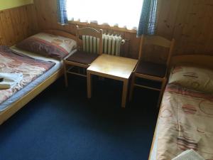 Postel nebo postele na pokoji v ubytování Lesní Bouda