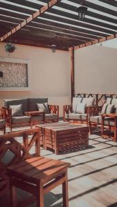 a living room with couches and a table and chairs at Abant Chalets in Riyadh