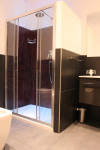 a bathroom with a shower with a glass door at Little Rose Lodge in Rome