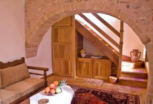 a living room with a couch and a table with fruit on it at Ardamis in Monemvasia
