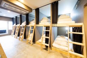 a row of bunk beds in a room at Ten to Ten Hostel in Sapporo
