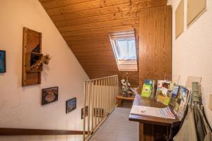 a room with a staircase with a wooden ceiling at Ferienwohnung Monika Haug in Immenstaad am Bodensee