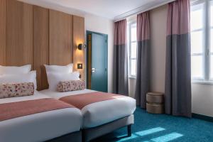Postel nebo postele na pokoji v ubytování Leonardo Boutique Hotel Paris Opera